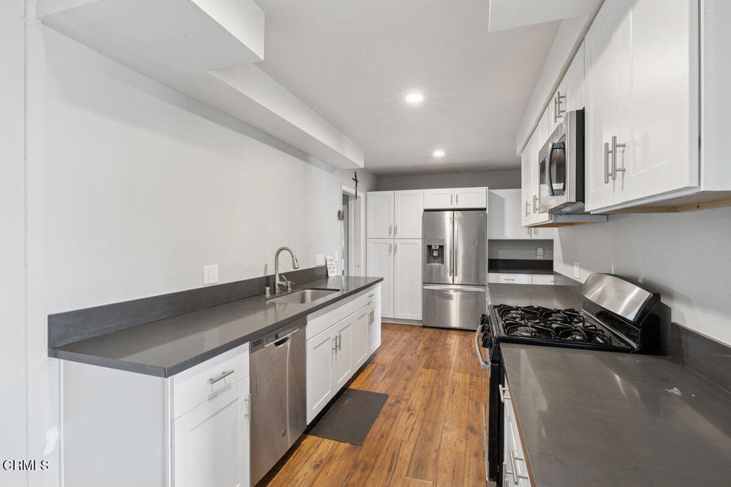 1841 South F Street Oxnard, CA 93033 - Photo 6 of 27 a kitchen with a sink stove and refrigerator