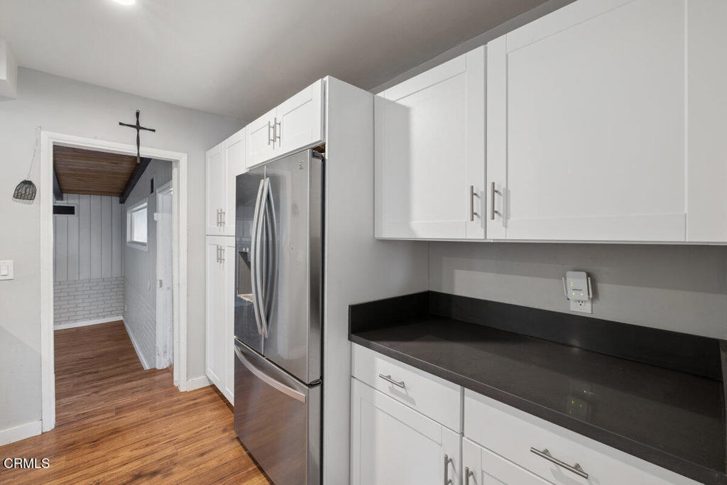 1841 South F Street Oxnard, CA 93033 - Photo 10 of 27 a kitchen with stainless steel appliances a refrigerator and cabinets