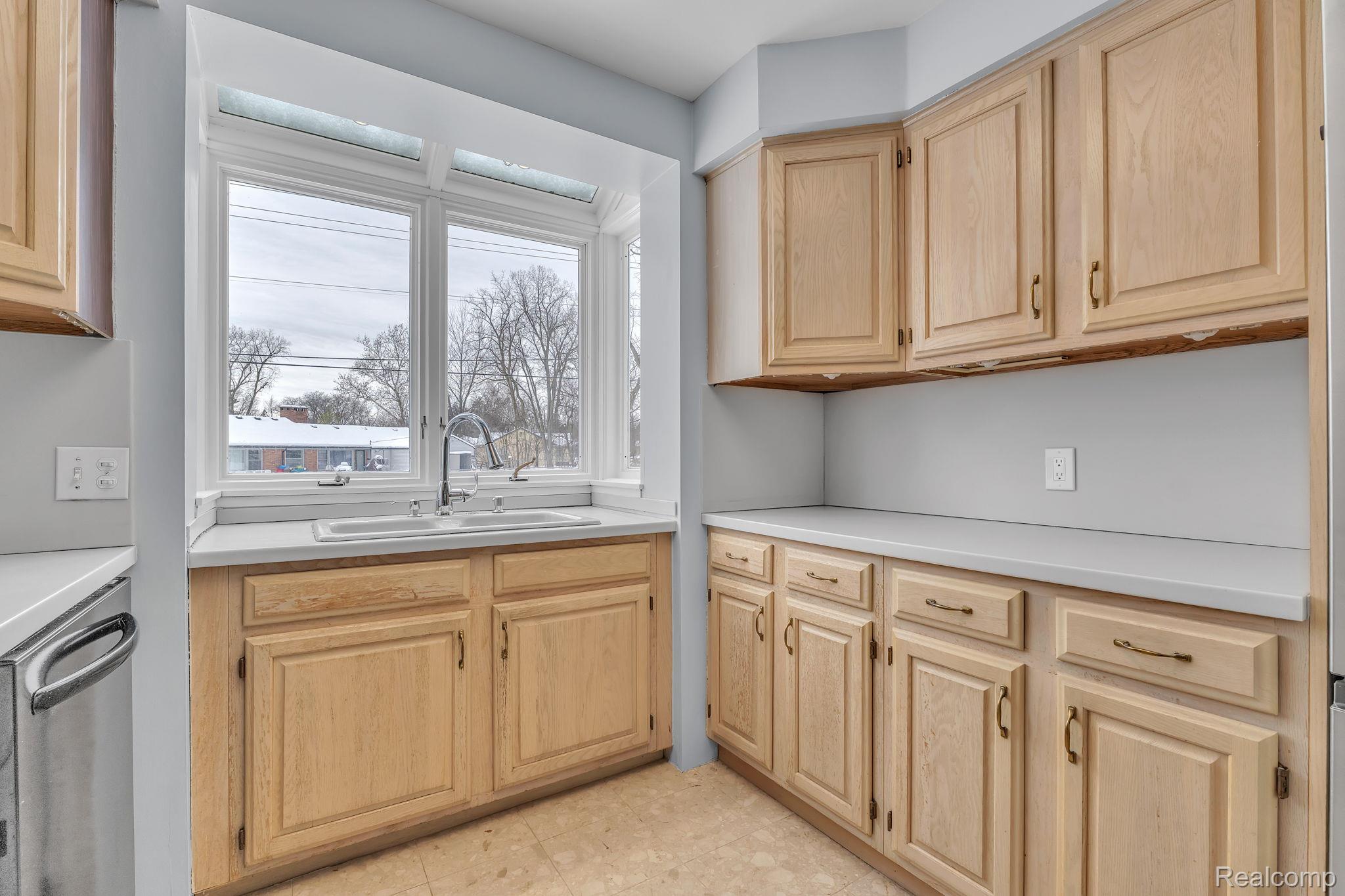 6576 Inkster Road West Bloomfield, MI 48322 - Photo 35 of 62 Kitchen with light brown cabinets, light countertops, and stainless steel dishwasher