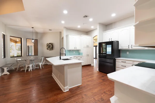 a bathroom with a bathtub sink and mirror