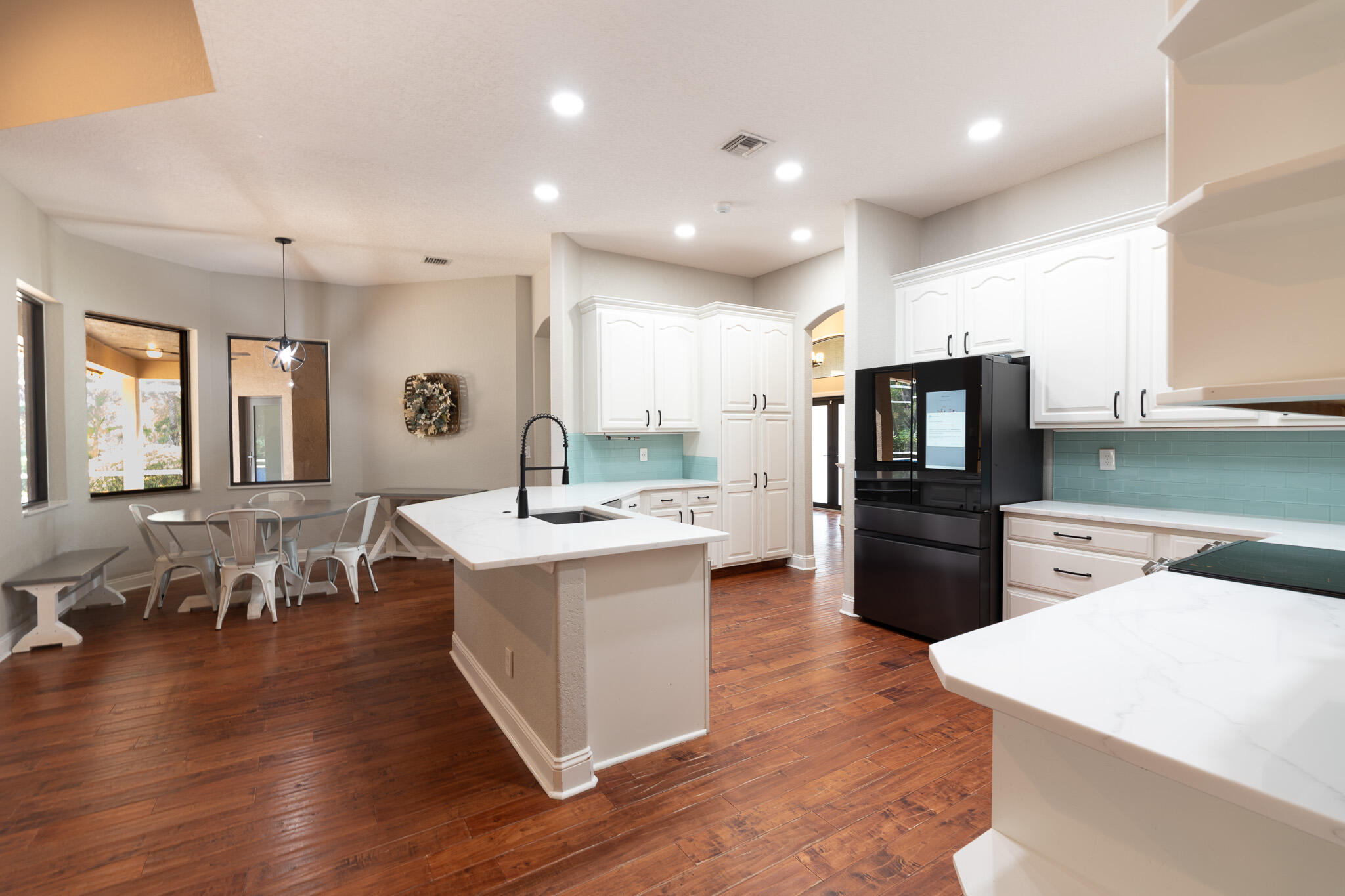 3516 185th Trail Loxahatchee, FL 33470 - Photo 13 of 56 a large kitchen with kitchen island a sink a center island stainless steel appliances and a center island