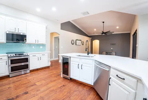 a bathroom with a granite countertop sink a toilet and shower