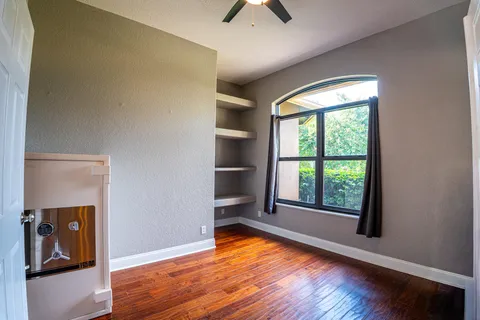 a view of walk in closet with empty racks