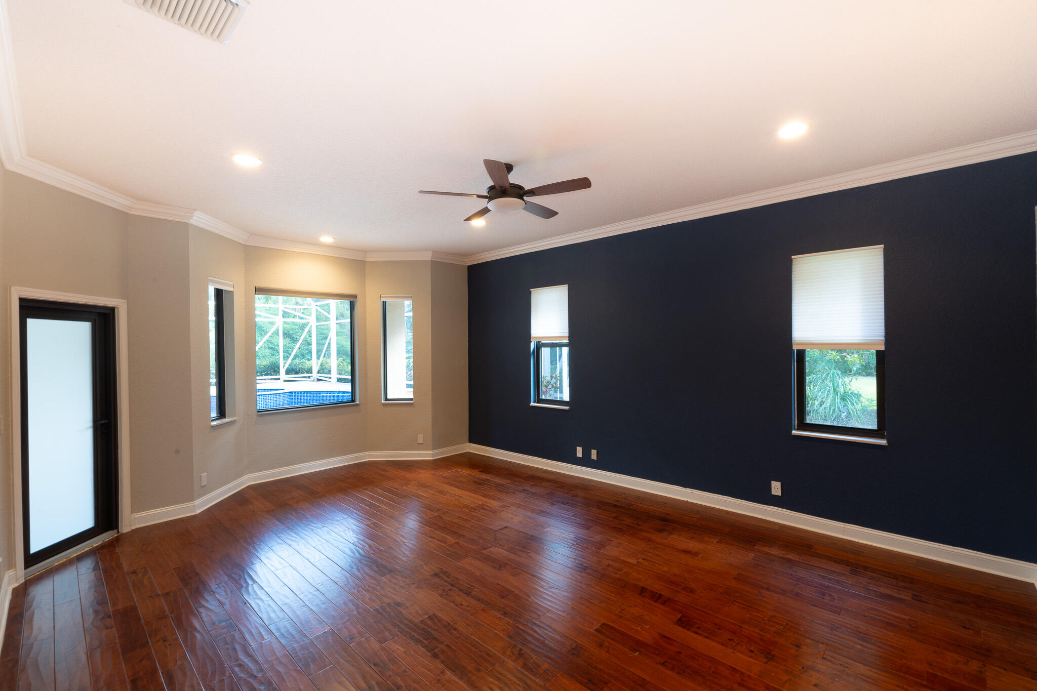 3516 185th Trail Loxahatchee, FL 33470 - Photo 19 of 56 a view of an empty room with a window and wooden floor