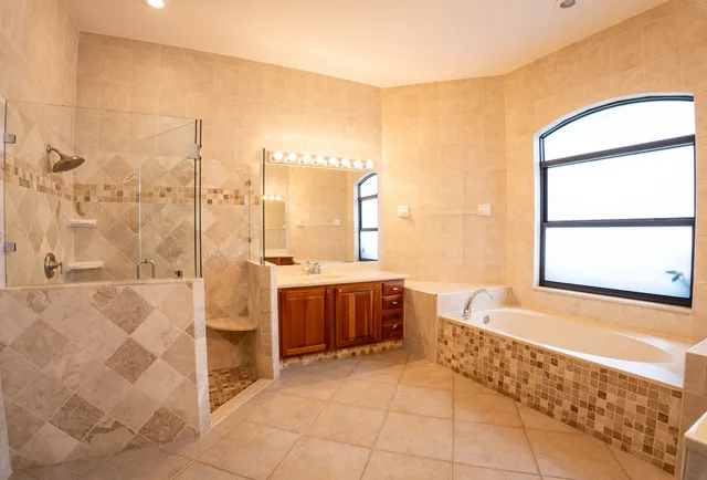 a living room with a bed furniture and a large window