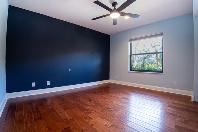 a living room with a bed furniture and a large window