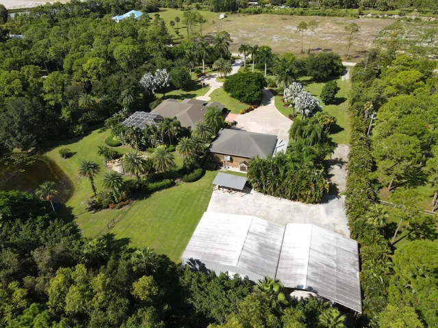 an aerial view of a residential houses with outdoor space