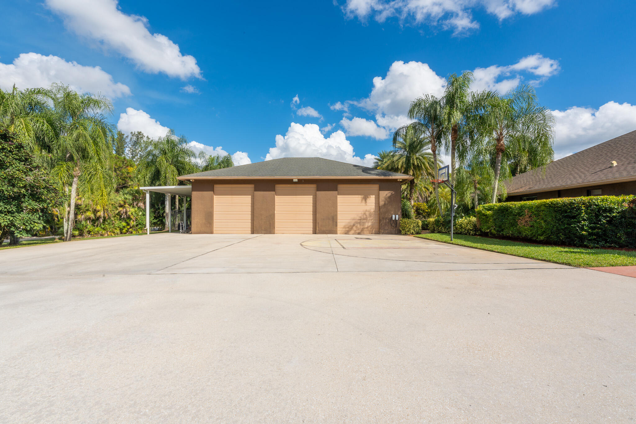3516 185th Trail Loxahatchee, FL 33470 - Photo 42 of 56 a front view of a house with a yard and potted plants
