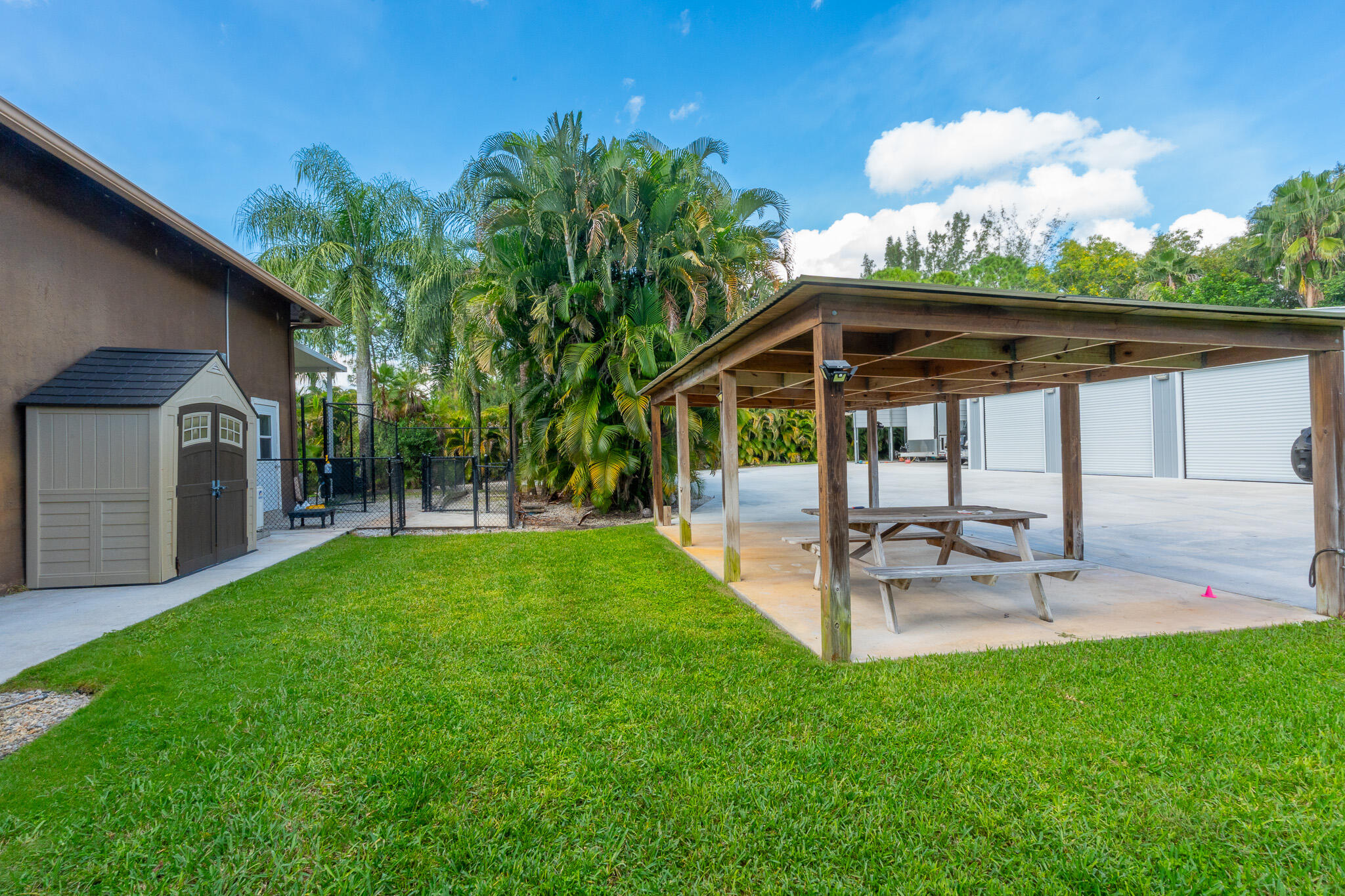 3516 185th Trail Loxahatchee, FL 33470 - Photo 46 of 56 a view of a patio with a table and chairs