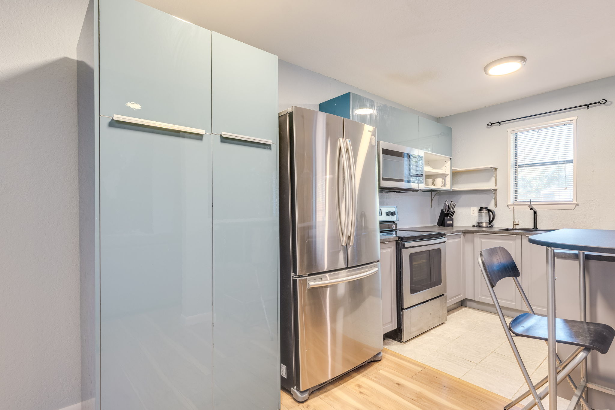4307 South 1st Street, Unit 101 Austin, TX 78745 - Photo 11 of 33 a kitchen with cabinets stainless steel appliances and window