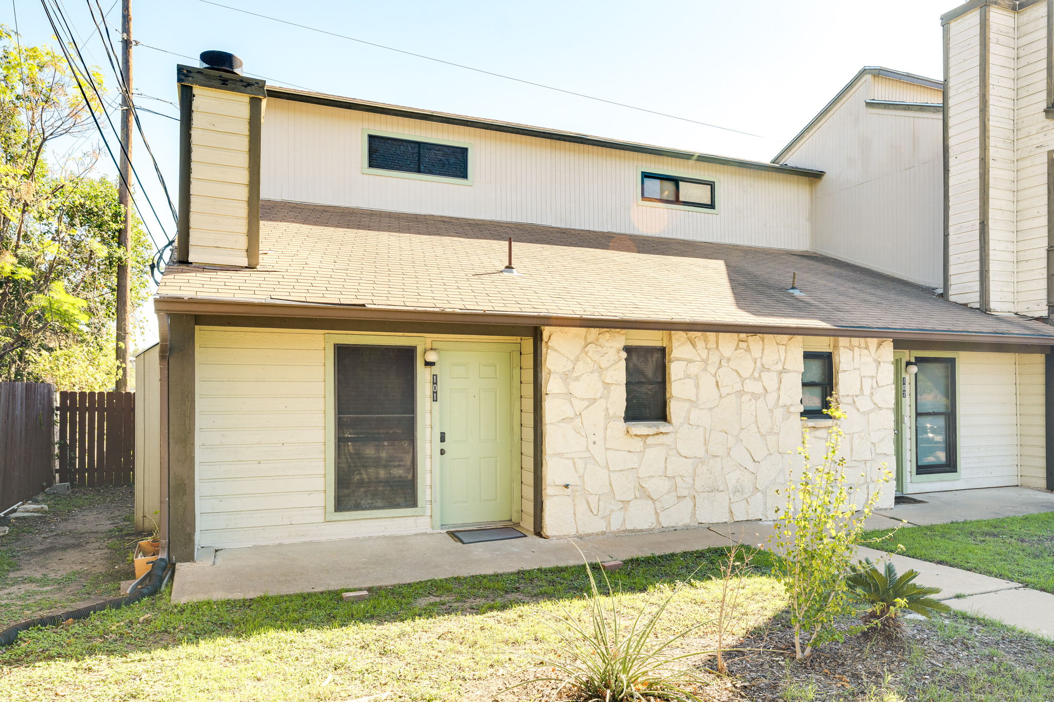 4307 South 1st Street, Unit 101 Austin, TX 78745 - Photo 2 of 33 a front view of a house with a yard