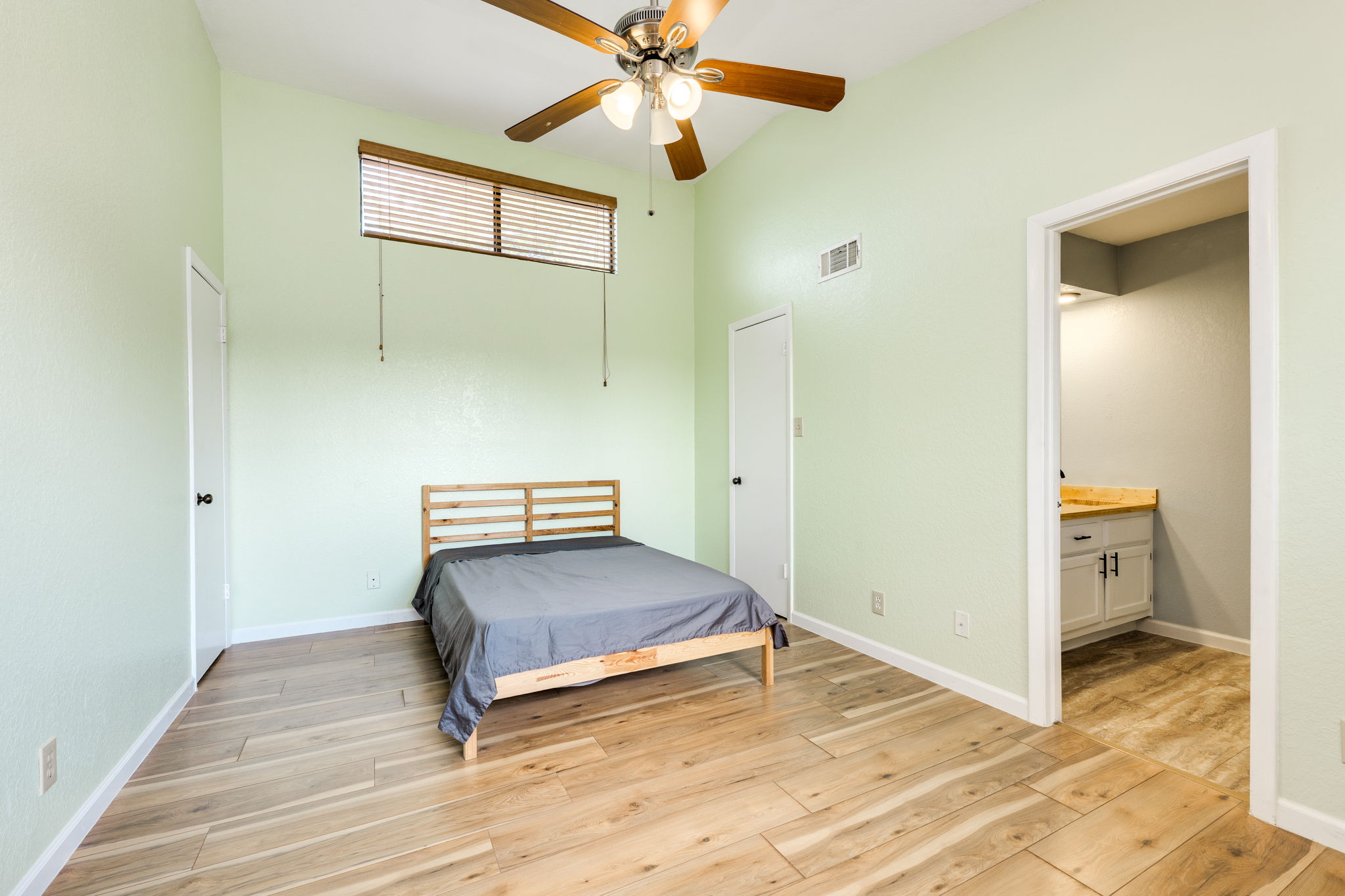 4307 South 1st Street, Unit 101 Austin, TX 78745 - Photo 24 of 33 a bedroom with a bed and a ceiling fan