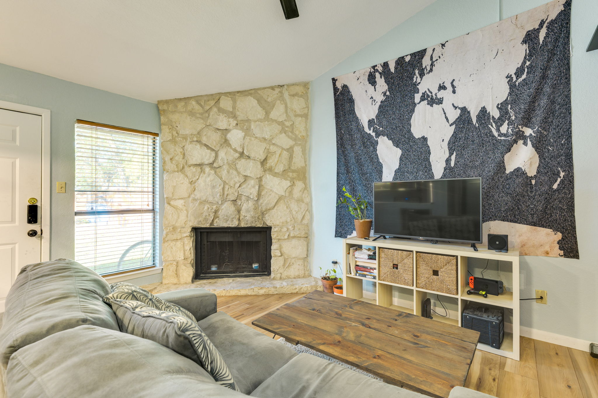 4307 South 1st Street, Unit 101 Austin, TX 78745 - Photo 8 of 33 a living room with a flat screen tv and a fireplace