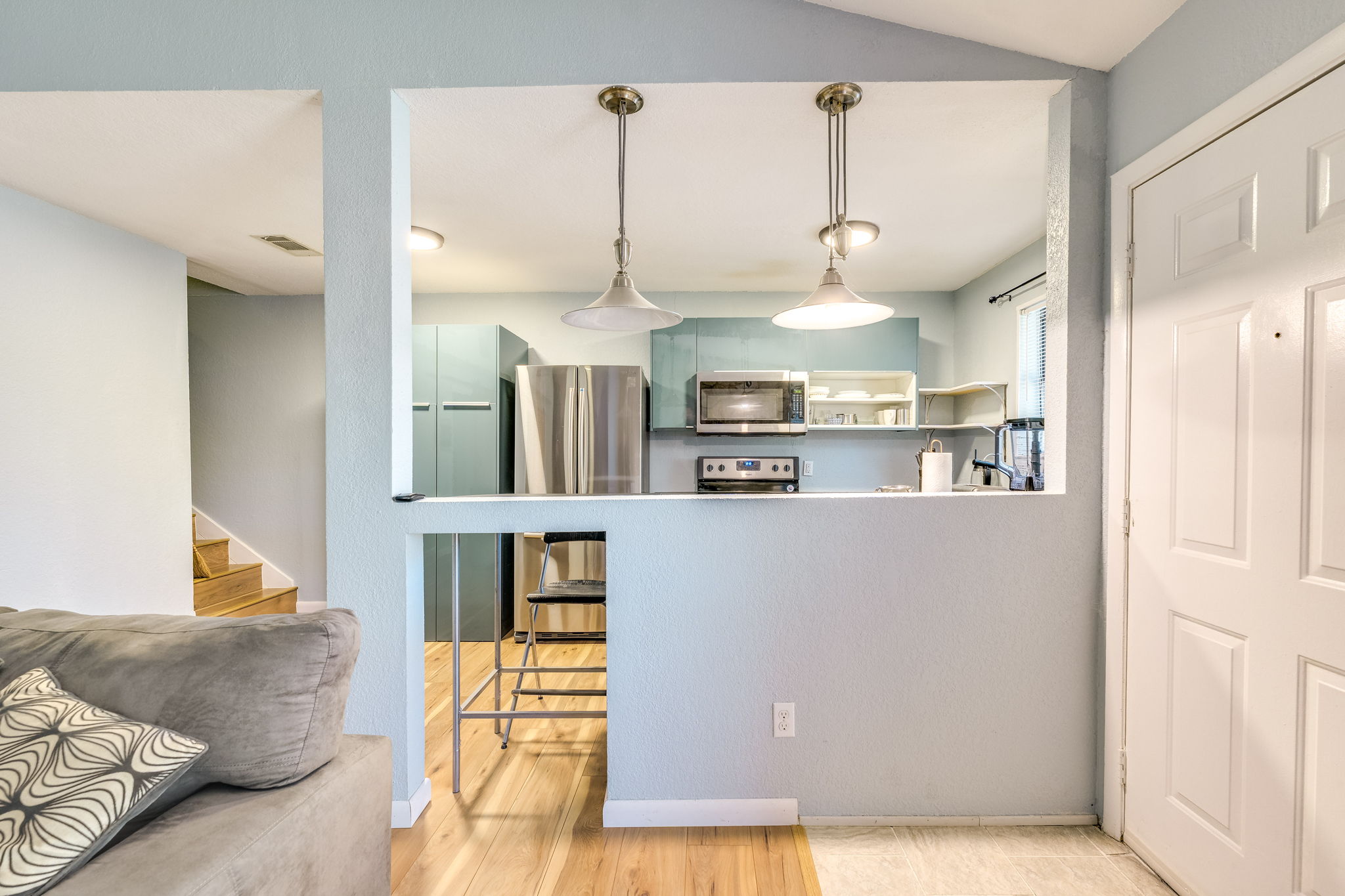 4307 South 1st Street, Unit 101 Austin, TX 78745 - Photo 10 of 33 a living room with kitchen island furniture and a chandelier
