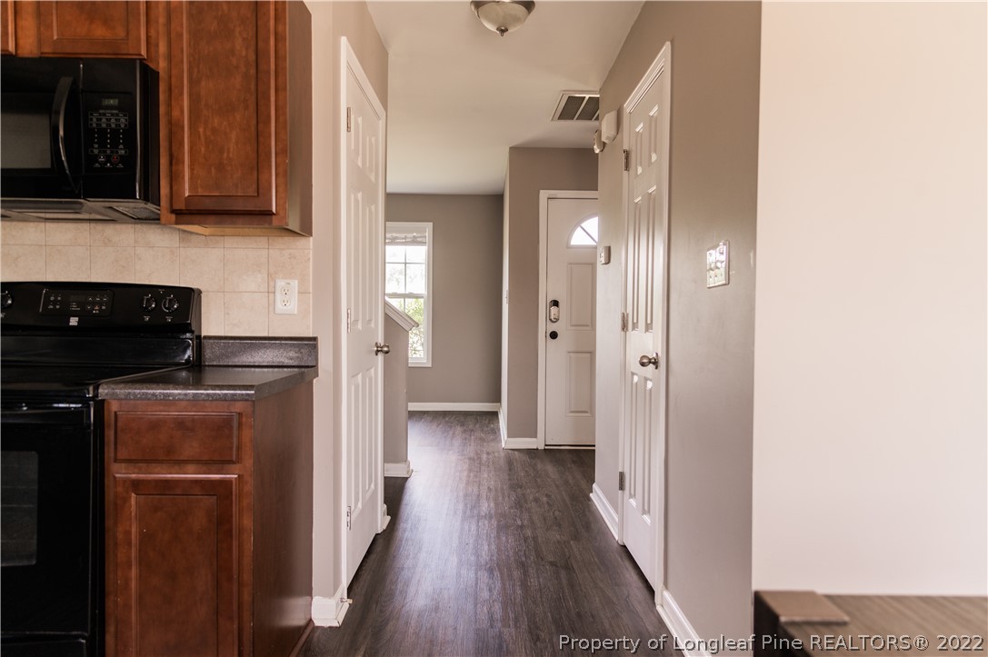 125 Cape Fear Road Raeford, NC 28376 - Photo 17 of 46 a kitchen with stainless steel appliances granite countertop a refrigerator and a stove top oven
