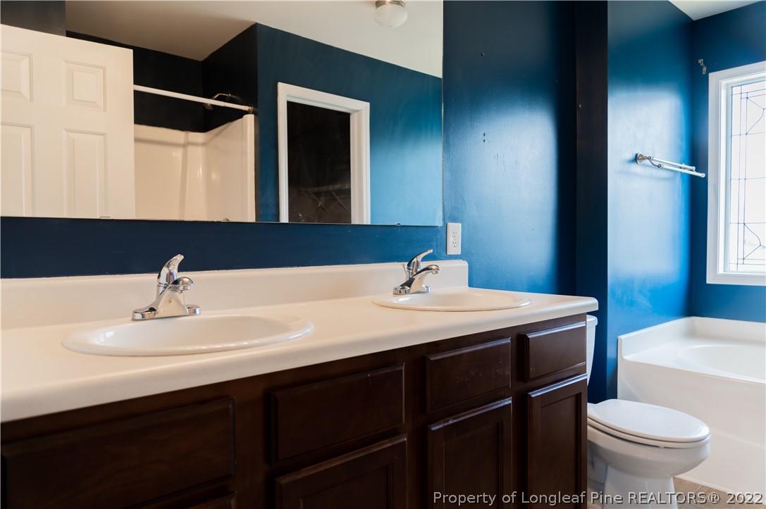 125 Cape Fear Road Raeford, NC 28376 - Photo 35 of 46 a bathroom with a sink vanity mirror and toilet
