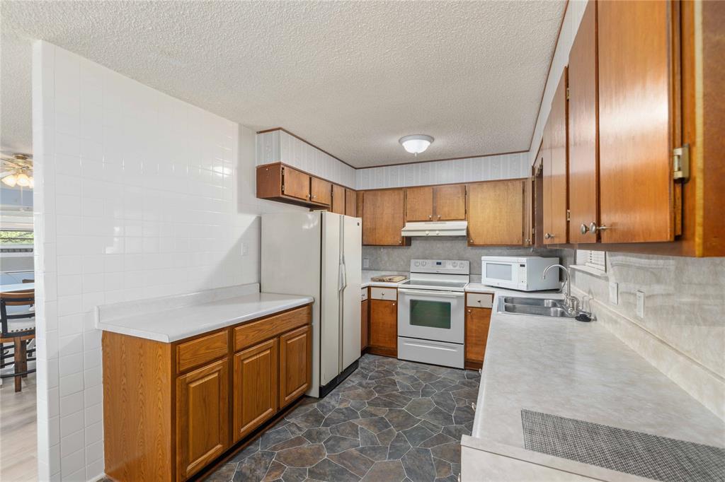 100 County Road 319 Early, TX 76802 - Photo 12 of 39 a kitchen with stainless steel appliances granite countertop a refrigerator a stove and a sink