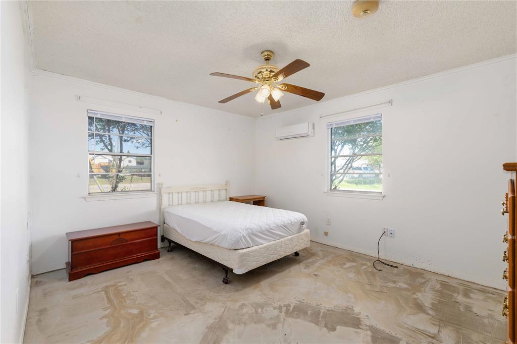 100 County Road 319 Early, TX 76802 - Photo 17 of 39 a bedroom with a bed and a window