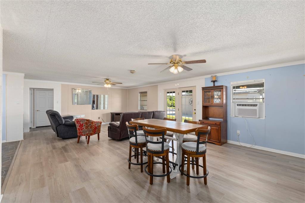 100 County Road 319 Early, TX 76802 - Photo 9 of 39 a view of a dining room with furniture and wooden floor