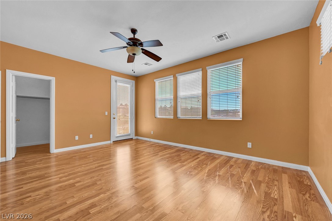 977 Sparkling Light Street Henderson, NV 89052 - Photo 6 of 75 This airy room features rich hardwood flooring and a private balcony entrance.