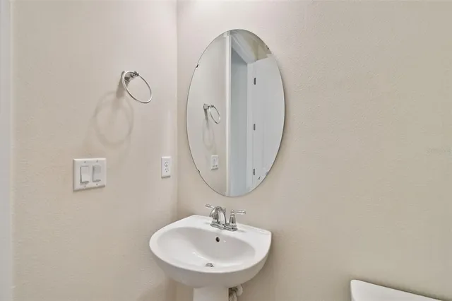 a bathroom with a sink vanity and a mirror