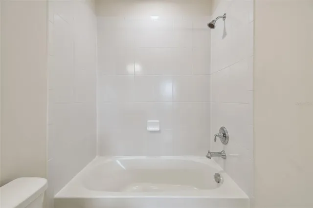 an aerial view of residential houses with yard and ocean view