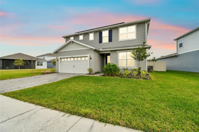 a front view of house with yard and green space
