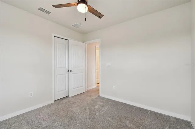 a aerial view of a house next to a yard