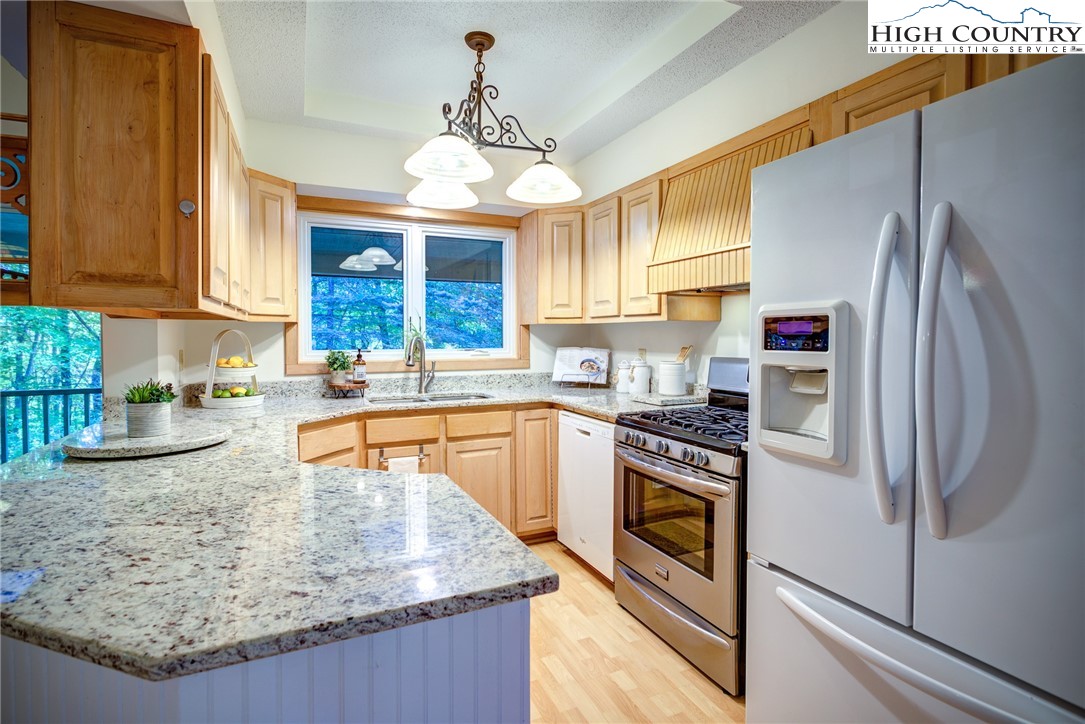 1267 Hopewell Church Road Boone, NC 28607 - Photo 21 of 50 a kitchen with stainless steel appliances granite countertop a sink stove and refrigerator