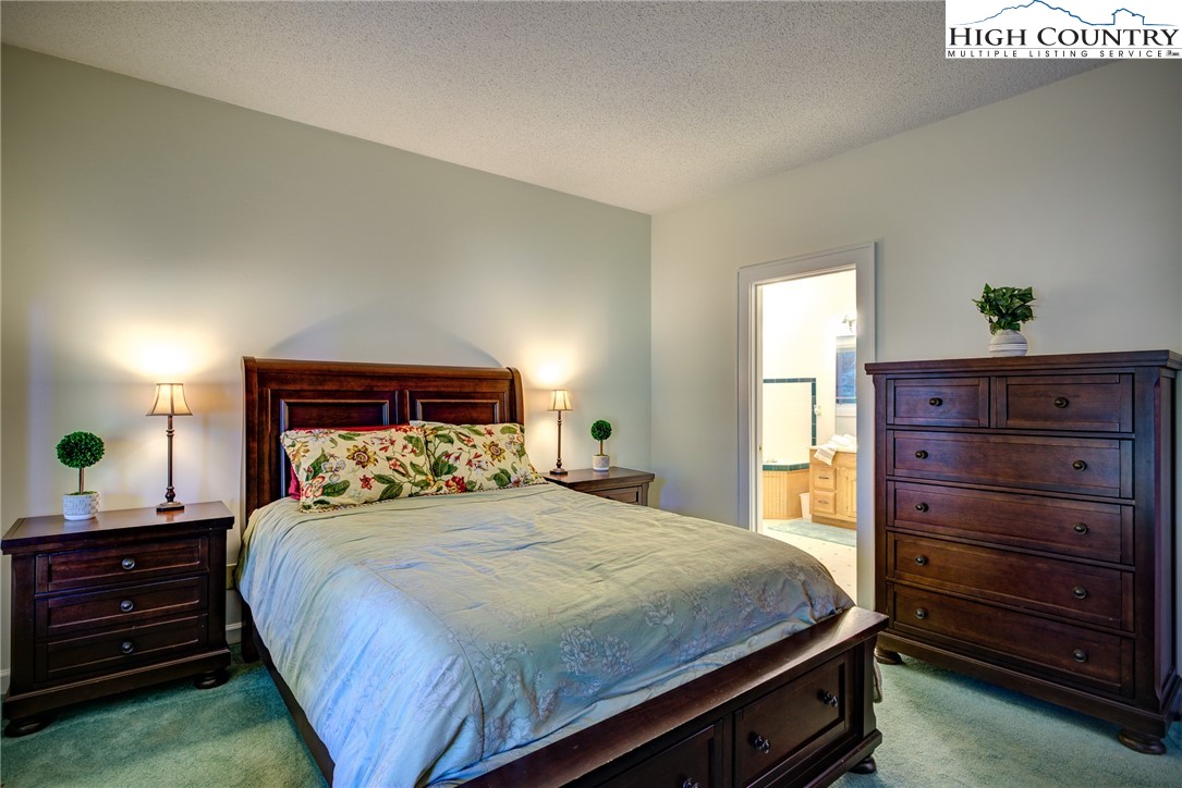 1267 Hopewell Church Road Boone, NC 28607 - Photo 25 of 50 a bedroom with a bed and a dresser