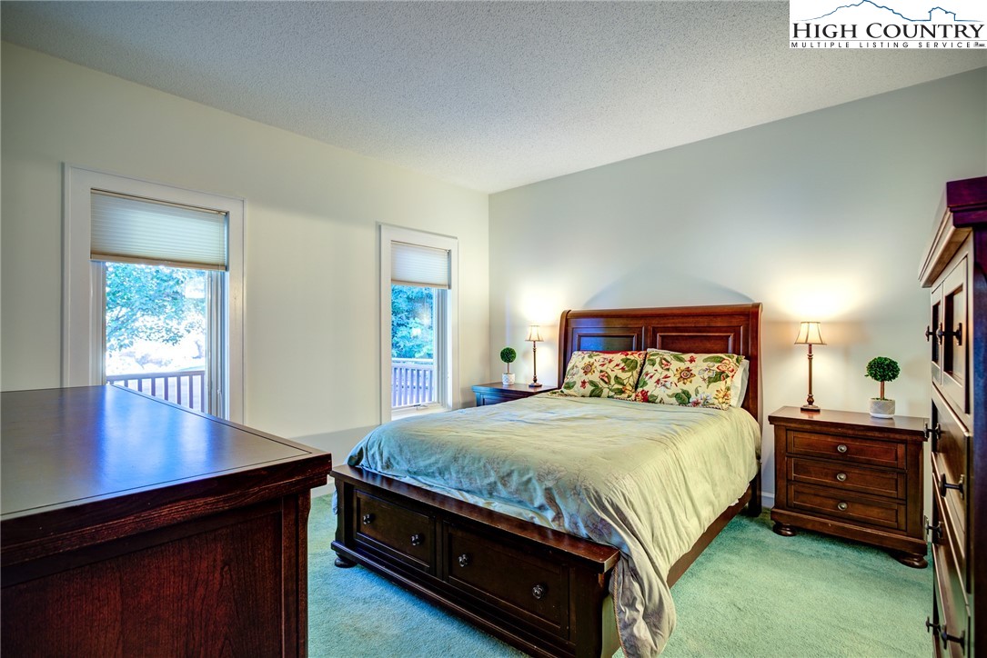 1267 Hopewell Church Road Boone, NC 28607 - Photo 26 of 50 a bedroom with a bed and a table in it