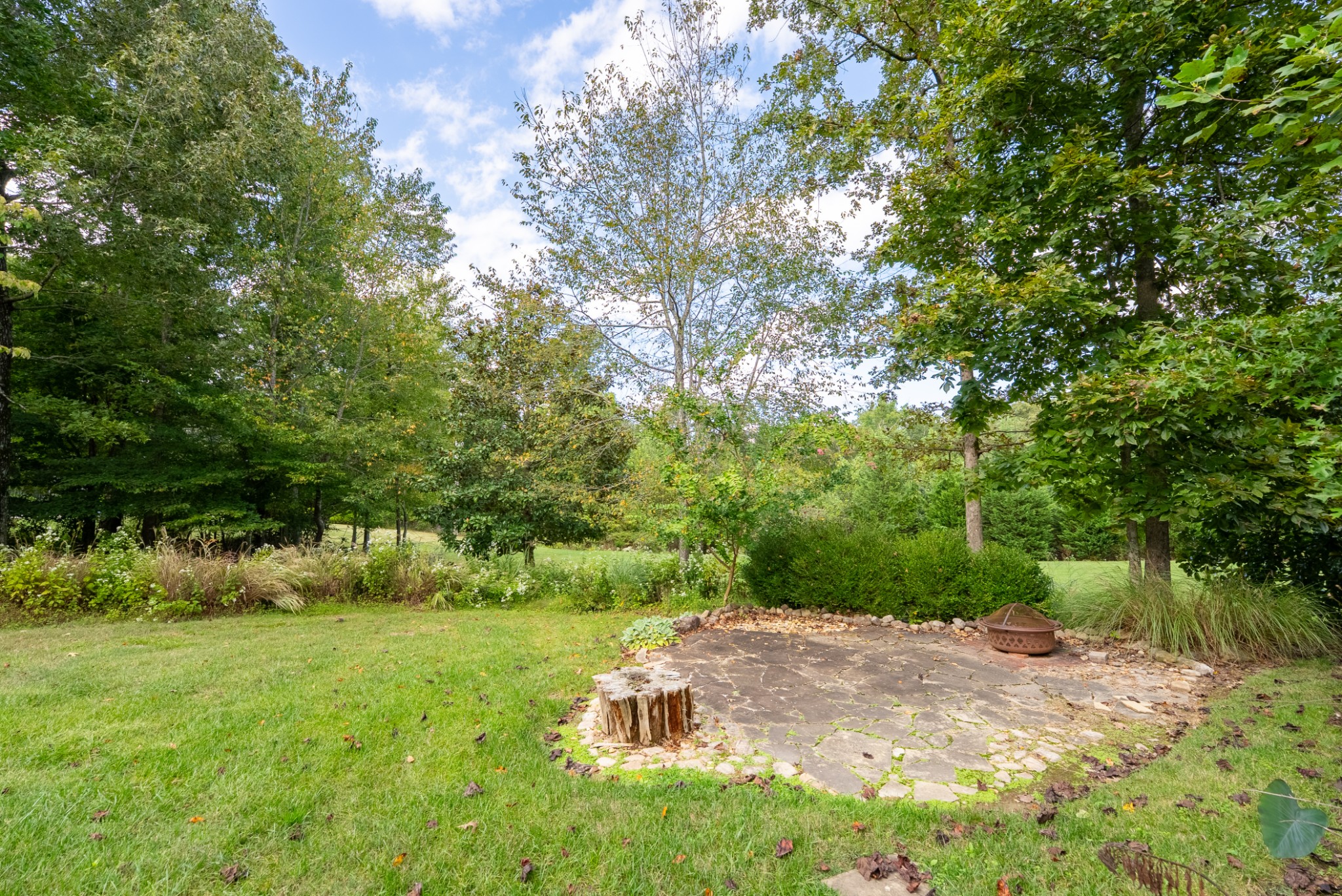 100 Point Circle Tullahoma, TN 37388 - Photo 30 of 33 a backyard of a house with trees and plants