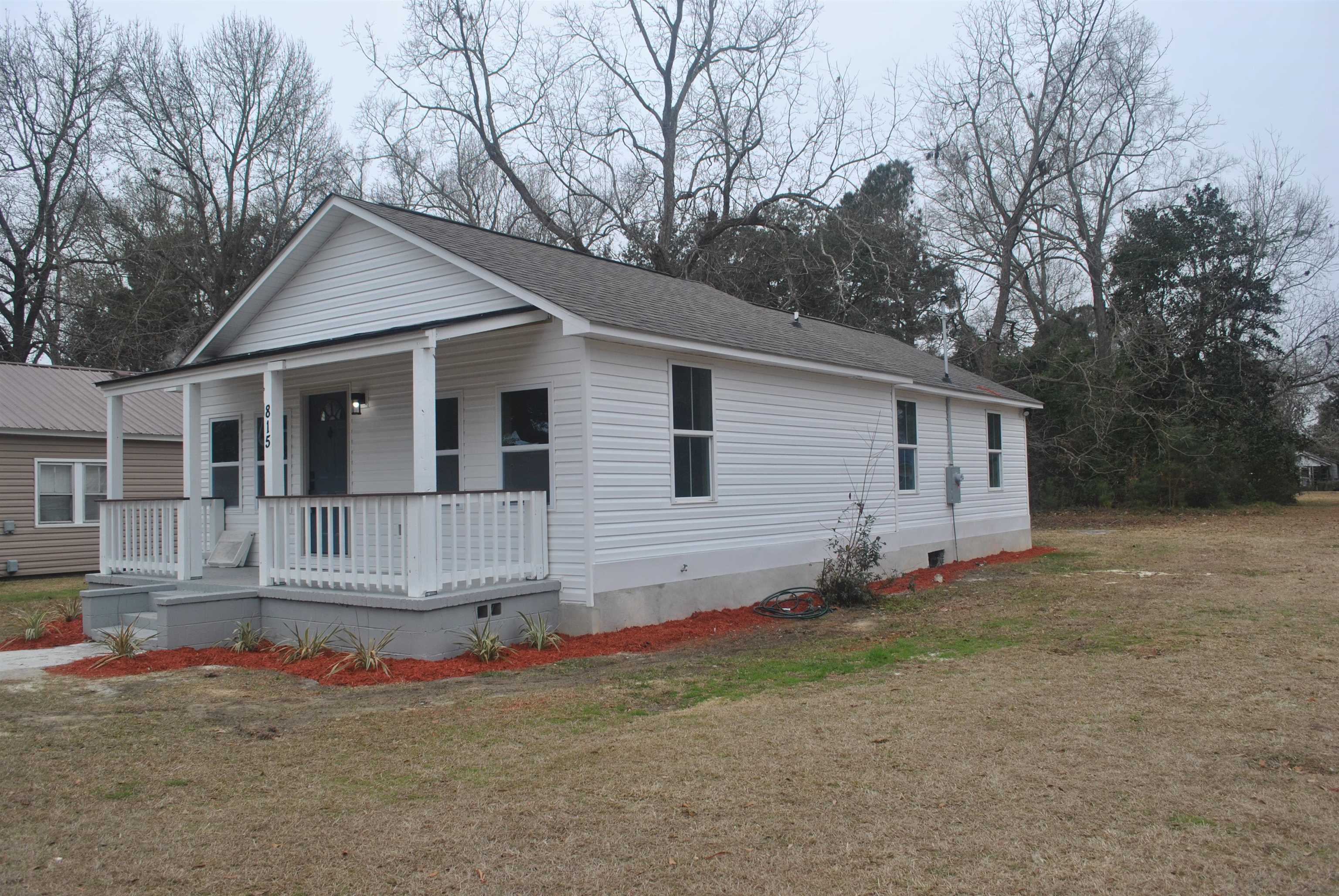 815 North Congdon Street Georgetown, SC 29440 - Photo 2 of 28 View of front of house featuring crawl space, a porch, a front lawn, and a shingled roof