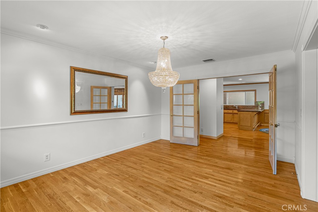 591 Busch Place Pasadena, CA 91105 - Photo 11 of 64 a big room with wooden floor chandelier and windows