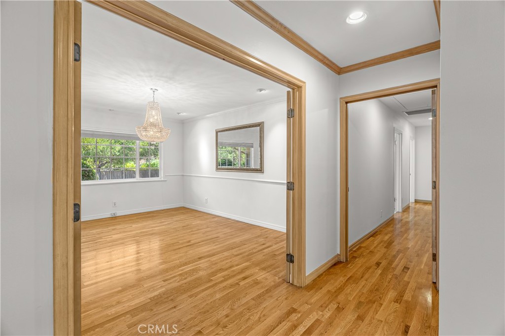 591 Busch Place Pasadena, CA 91105 - Photo 13 of 64 a view of an empty room with wooden floor and windows