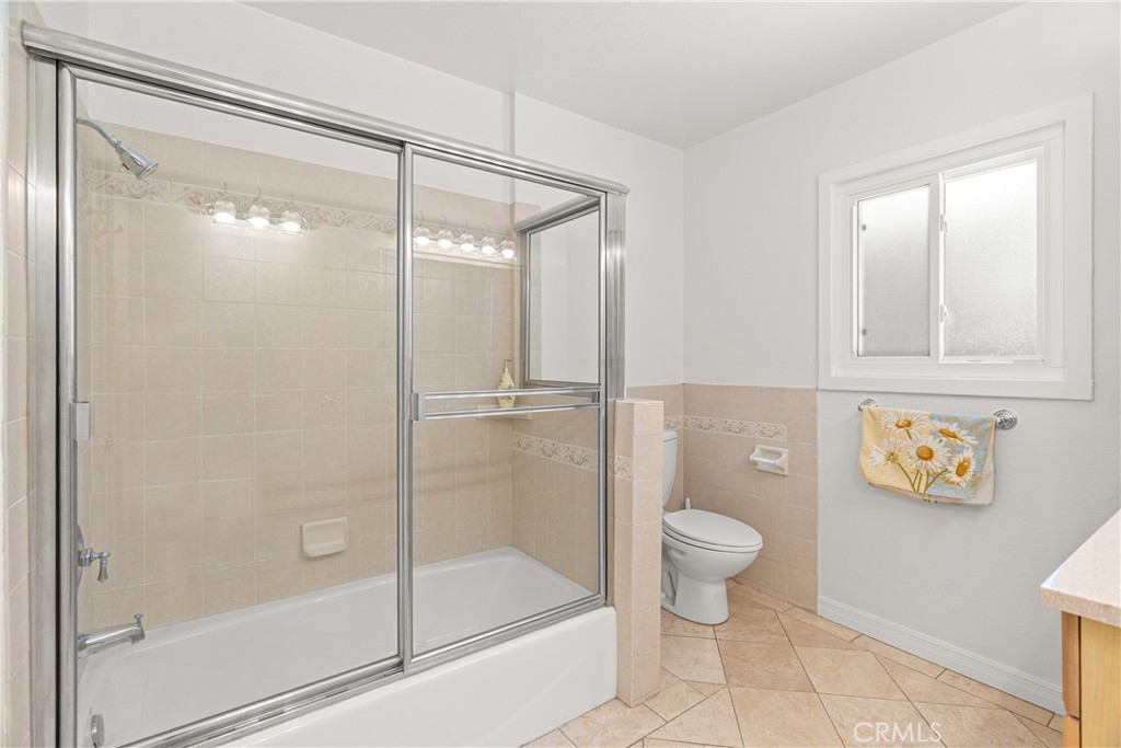 591 Busch Place Pasadena, CA 91105 - Photo 21 of 64 a bathroom with a glass shower door