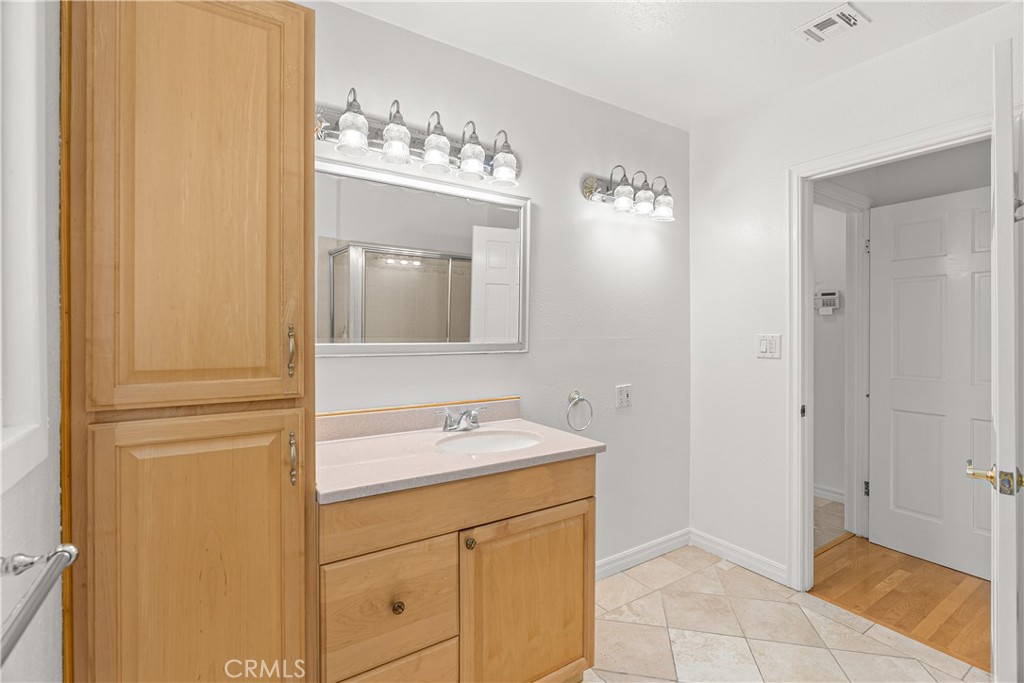 591 Busch Place Pasadena, CA 91105 - Photo 22 of 64 a bathroom with a sink a vanity and a mirror
