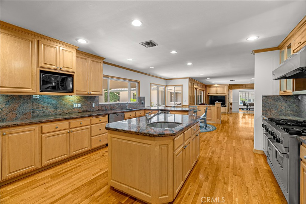 591 Busch Place Pasadena, CA 91105 - Photo 26 of 64 a large kitchen with stainless steel appliances granite countertop a stove a sink dishwasher and a microwave
