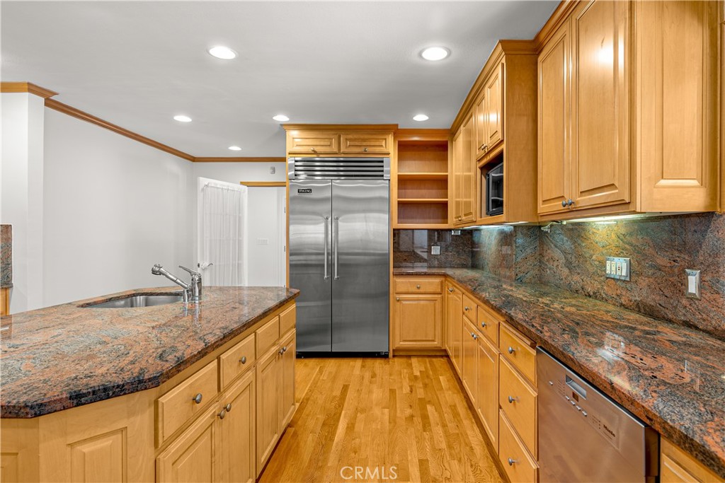 591 Busch Place Pasadena, CA 91105 - Photo 28 of 64 a kitchen with stainless steel appliances granite countertop a sink and a refrigerator
