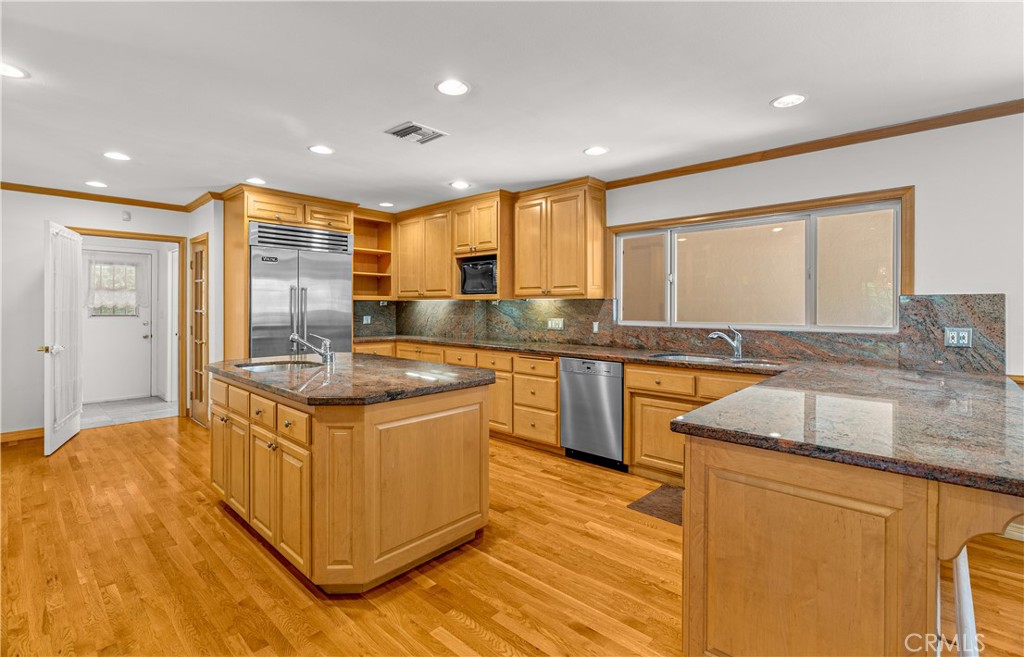 591 Busch Place Pasadena, CA 91105 - Photo 30 of 64 a kitchen with stainless steel appliances granite countertop a sink a stove and a wooden floors
