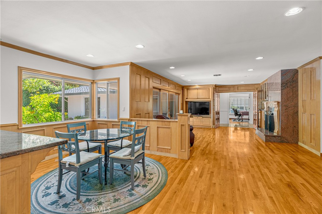 591 Busch Place Pasadena, CA 91105 - Photo 31 of 64 a living room with dining table a table and chairs with wooden floor