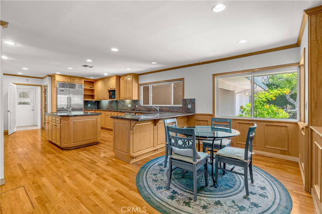 591 Busch Place Pasadena, CA 91105 - Photo 32 of 64 a kitchen with stainless steel appliances granite countertop a stove a sink a refrigerator dining table and chairs