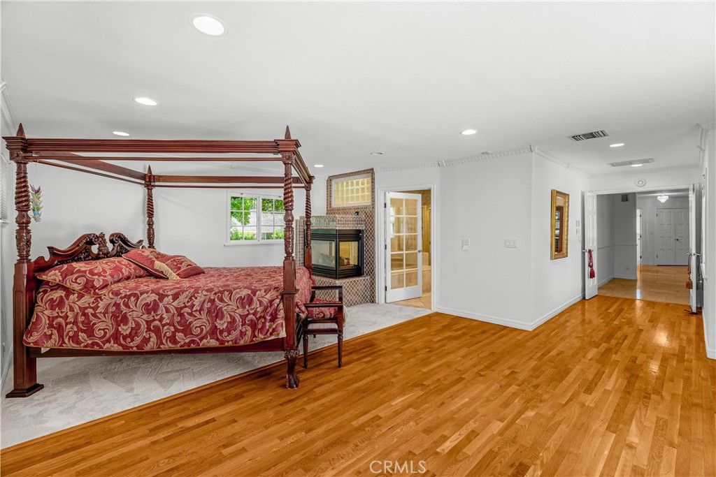 591 Busch Place Pasadena, CA 91105 - Photo 42 of 64 a bedroom with a large bed and wooden floor