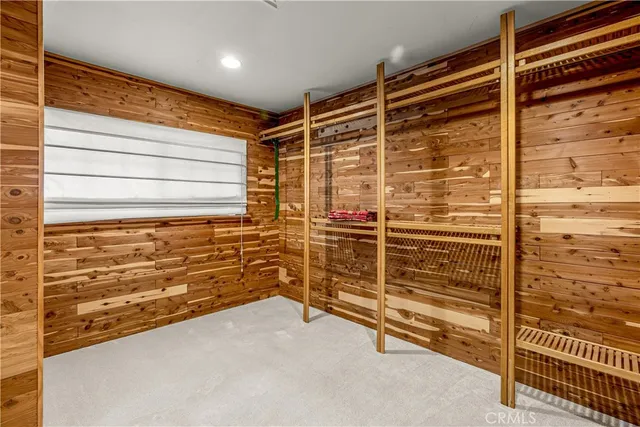 an aerial view of a house with swimming pool and lake view