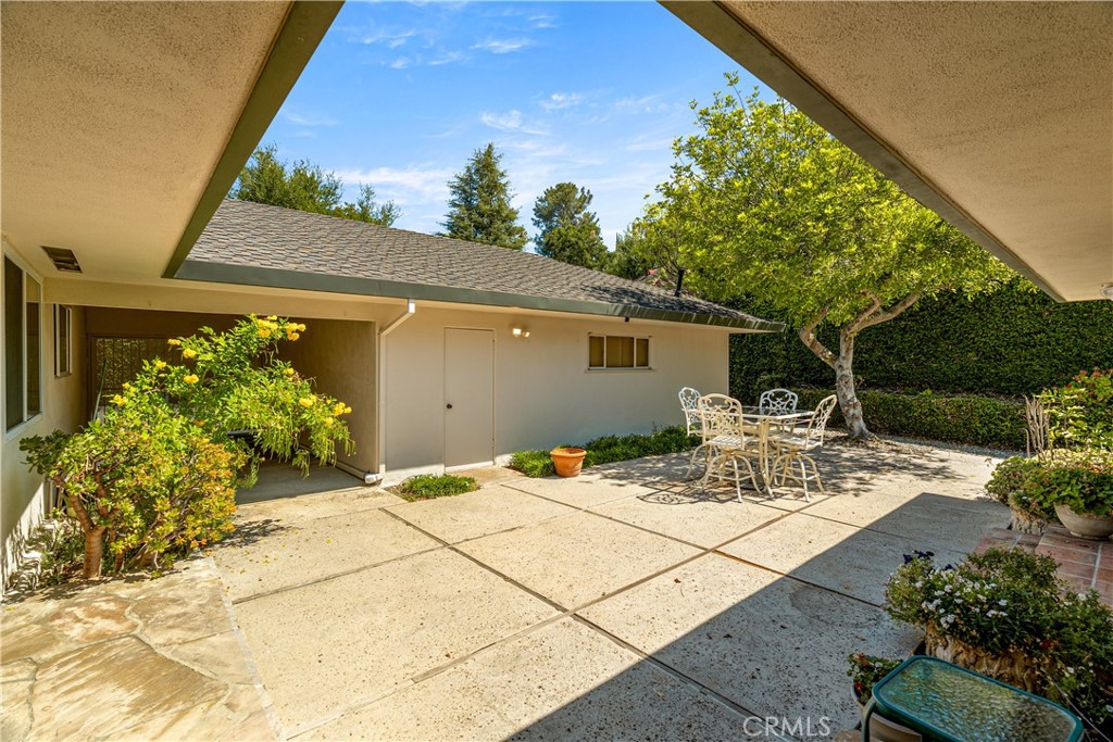 591 Busch Place Pasadena, CA 91105 - Photo 50 of 64 a view of a backyard with table and chairs potted plants