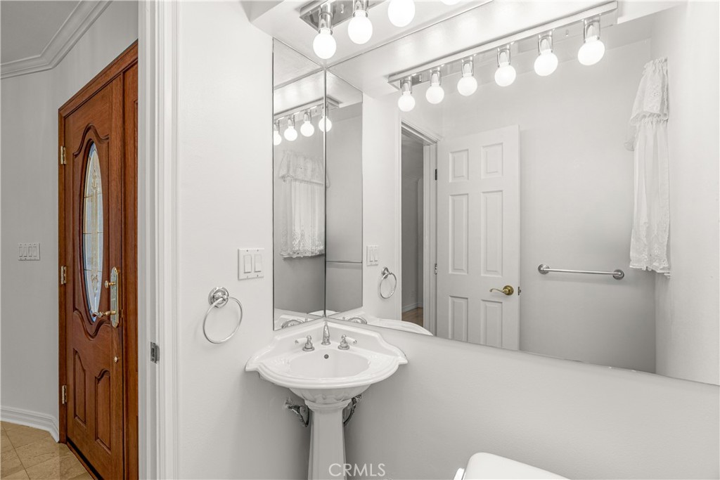 591 Busch Place Pasadena, CA 91105 - Photo 7 of 64 a bathroom with a sink mirror and shower