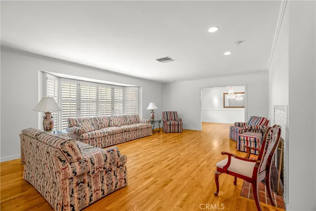a view of empty room with wooden floor and window
