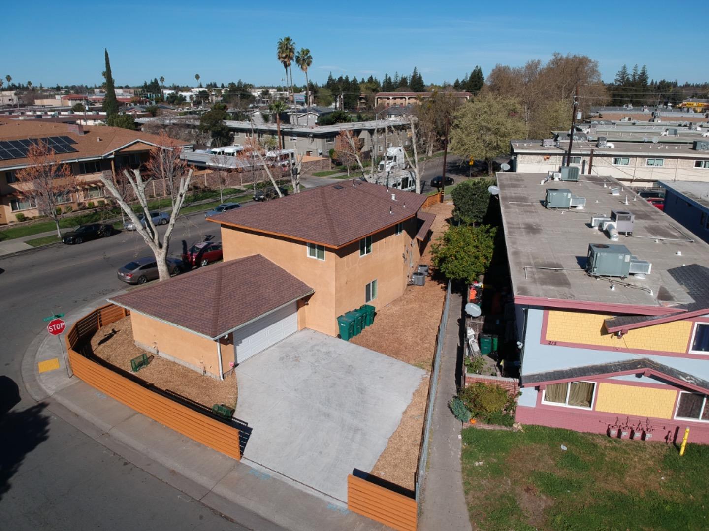 an aerial view of a house with a garden and trees