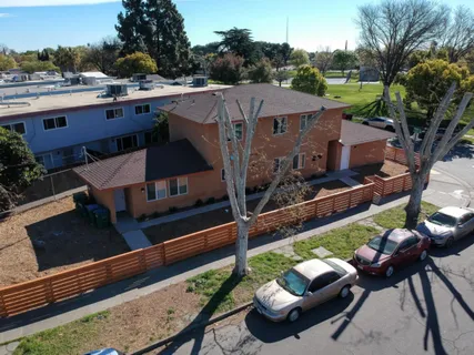 an aerial view of a house with garden space and sitting area