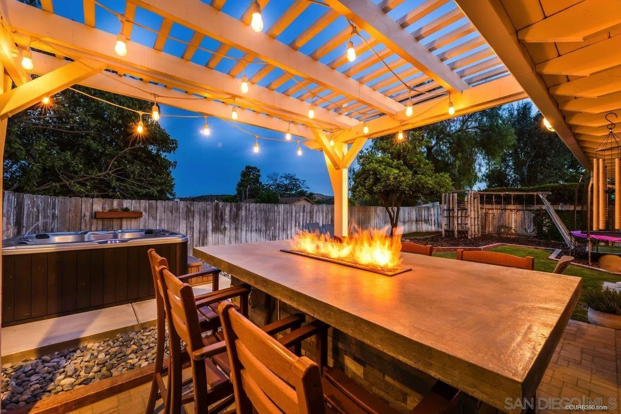 13317 Arikara Drive Poway, CA 92064 - Photo 1 of 52 a view of a patio with table and chairs with wooden floor and fence